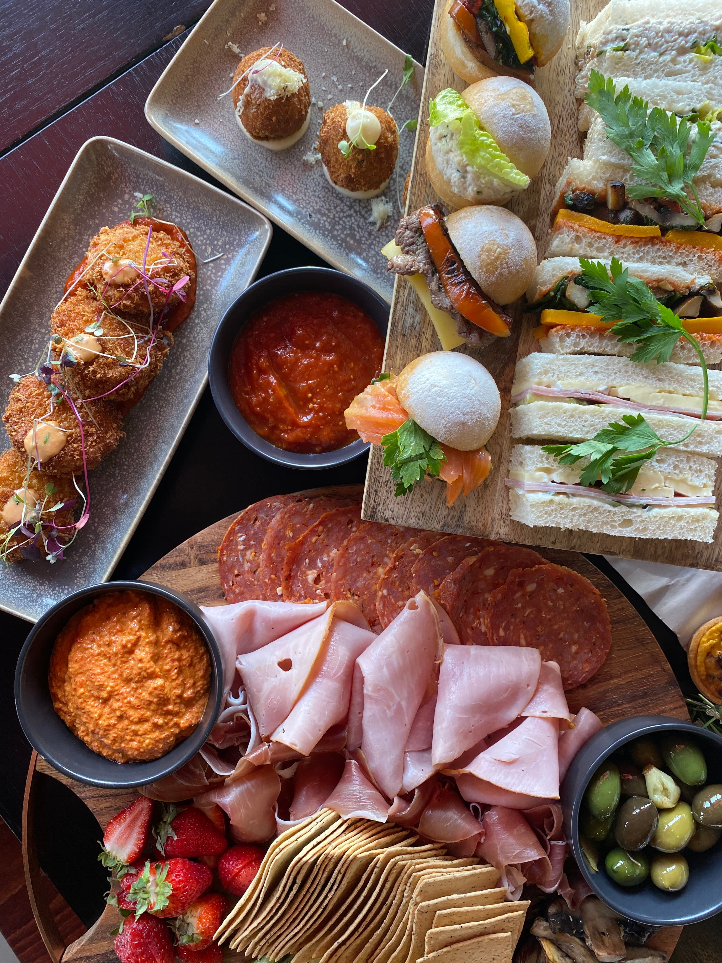 Arancini, sandwiches, and cheese board by Niche catering